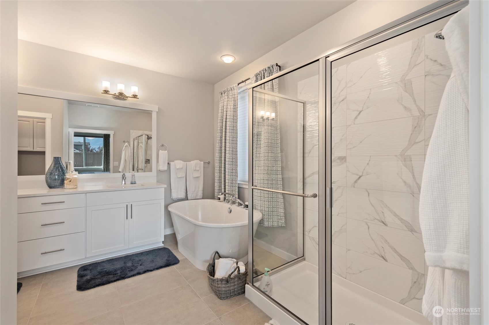 984 Rainier Loop Mount Vernon, WA 98274 - Photo 21 of 40 a spacious bathroom with a shower sink and mirror