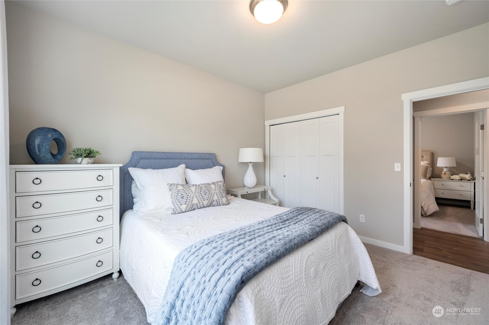 984 Rainier Loop Mount Vernon, WA 98274 - Photo 25 of 40 a bedroom with a bed and a mirror on dresser