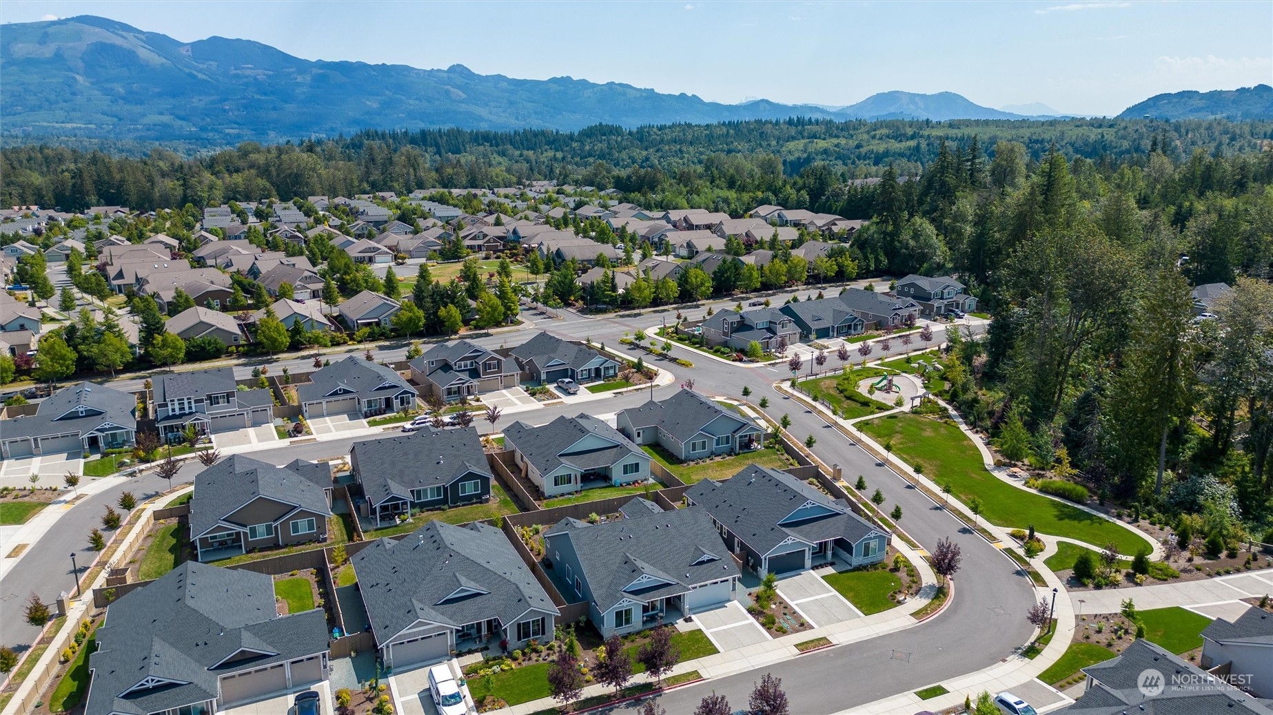 984 Rainier Loop Mount Vernon, WA 98274 - Photo 38 of 40 an aerial view of a city with lots of residential buildings and mountain view in back