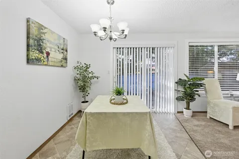 a view of a dining room with furniture and a potted plant