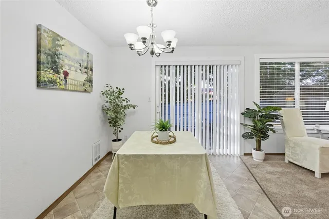a view of a dining room with furniture and a potted plant
