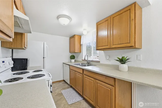a kitchen that has a sink and a stove