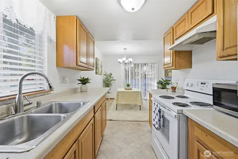 a kitchen with a sink stove and cabinets