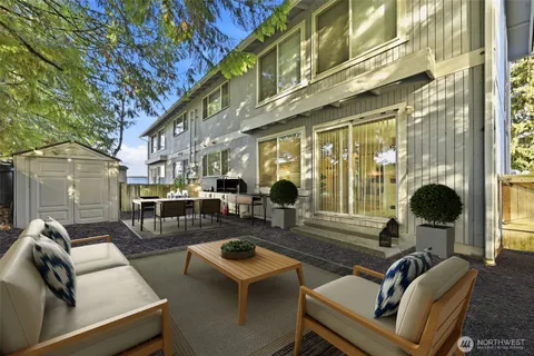 a view of a patio with couches table and chairs and potted plants