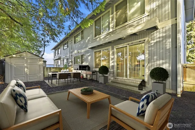 a view of a patio with couches table and chairs and potted plants
