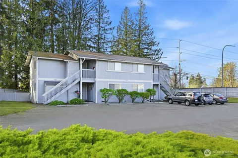 a front view of a house with a yard and outdoor seating