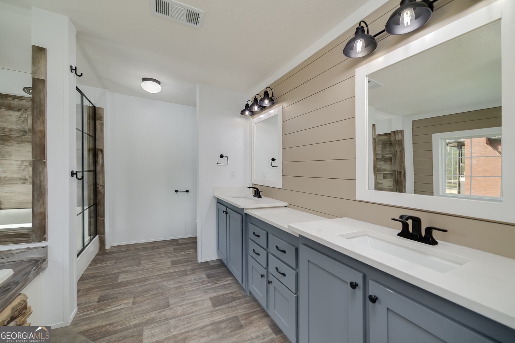 595 Barnetts Bridge Road Jackson, GA 30233 - Photo 30 of 47 a spacious bathroom with a double vanity sink a mirror and a shower