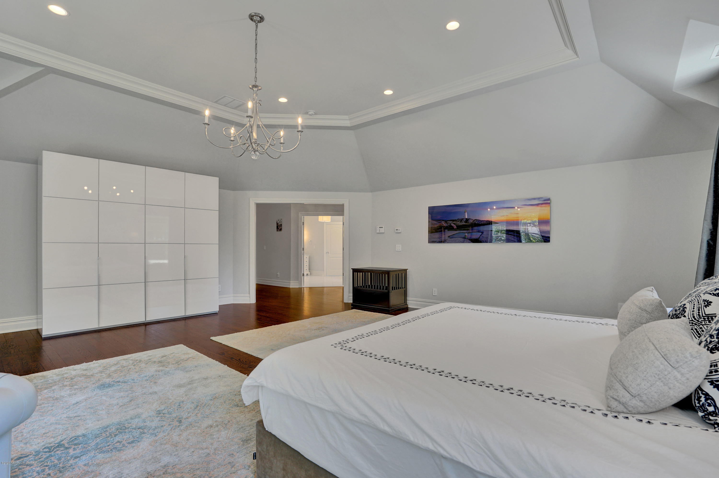 7 Heathcliff Road Rumson, NJ 07760 - Photo 43 of 61 a bedroom with a large bed and a chandelier
