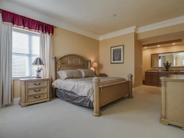 a spacious bedroom with a bed and a dresser