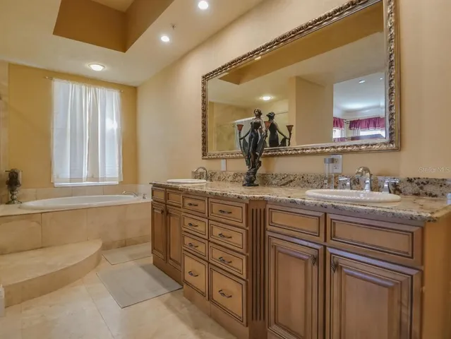 a bathroom with a granite countertop sink mirror and