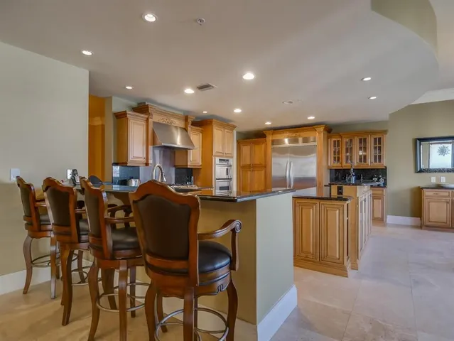 a large kitchen with a table and chairs