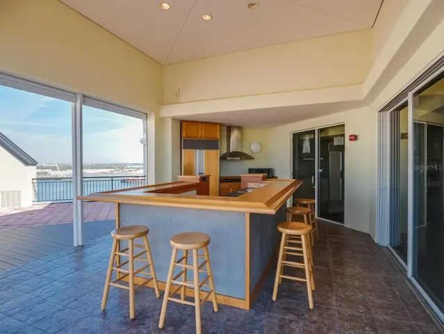 a dining room with a table chairs and a kitchen view