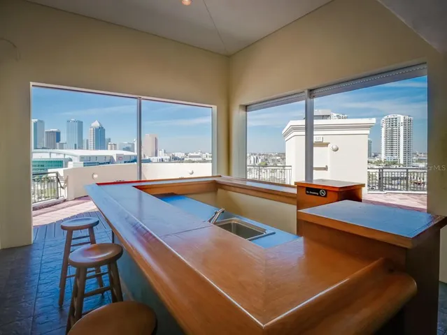 a room with pool table and windows