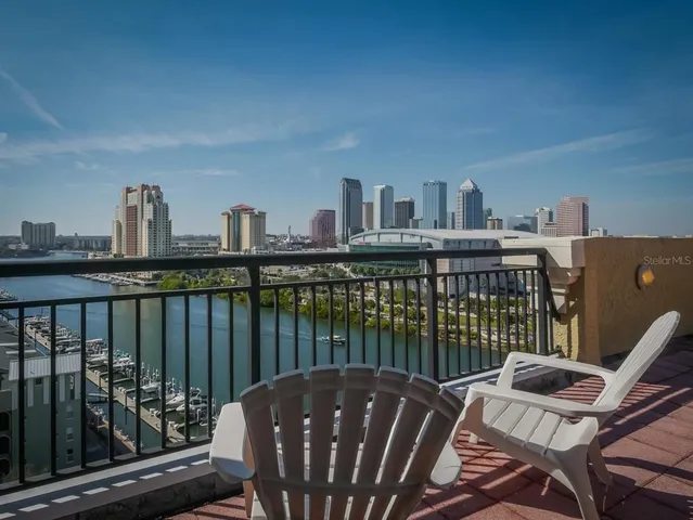 a view of a balcony with two chairs and a wooden floor