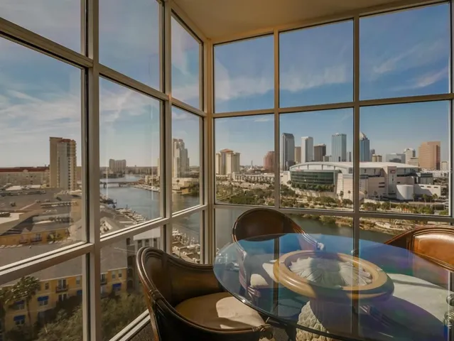 a living room with furniture and a floor to ceiling window