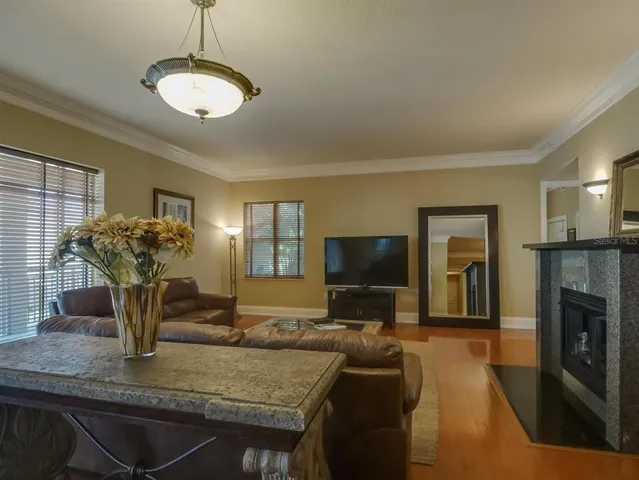 a kitchen view with living room and fireplace