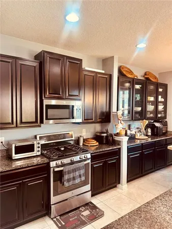 a kitchen with a sink stove and refrigerator