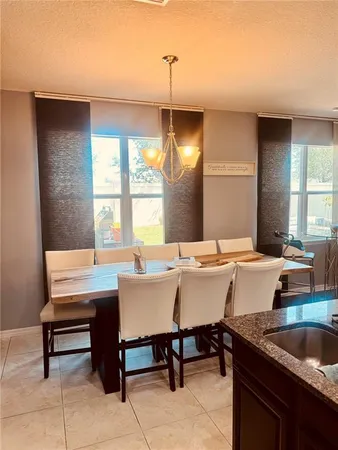 a kitchen with a table chairs and sink