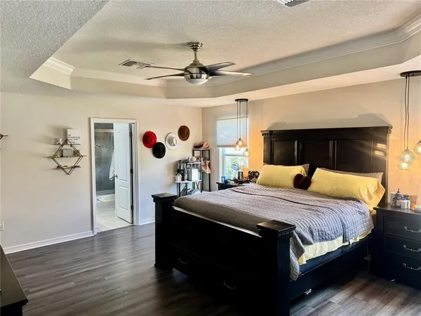 a bedroom with a bed and a chandelier