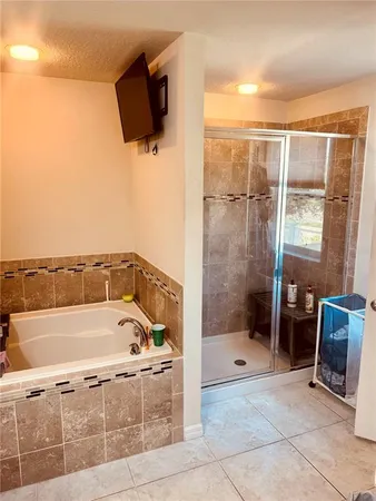 a bathroom with a bathtub and a shower