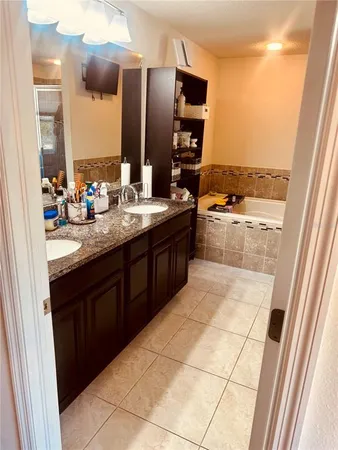 a large kitchen with a sink and dishwasher a refrigerator with wooden cabinets