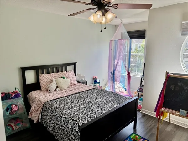 a bedroom with a bed and a chandelier