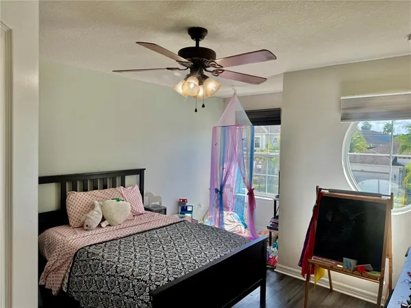 a bedroom with a bed and a chandelier
