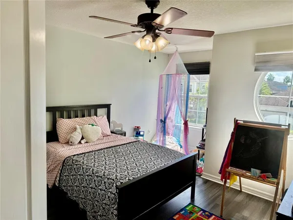 a bedroom with a bed and a flat tv screen