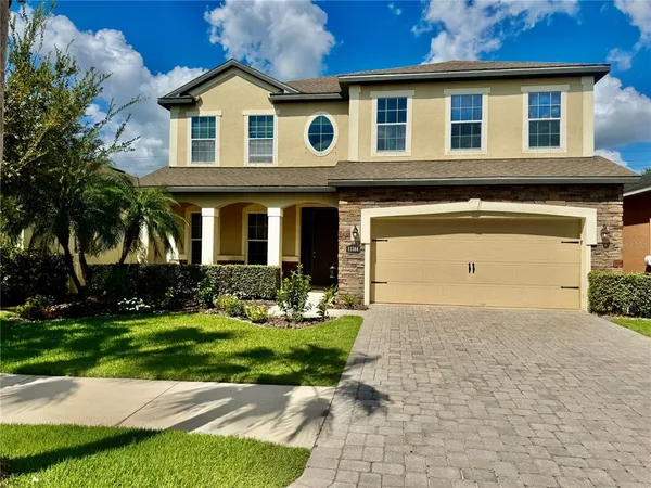 a front view of a house with a yard and garage