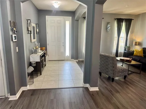 a view of a room with wooden floor and furniture