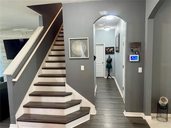 a view of entryway and hall with wooden floor