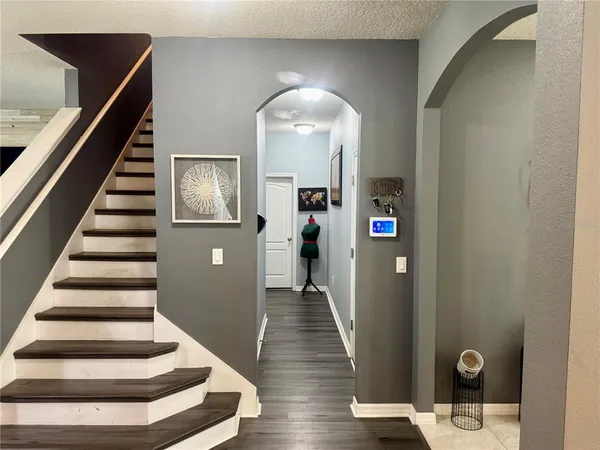 a view of entryway and hall with wooden floor