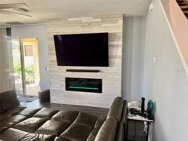 a living room with fireplace furniture and a flat screen tv