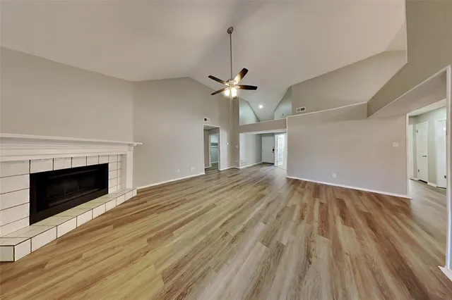 wooden floor in an empty room with a fireplace