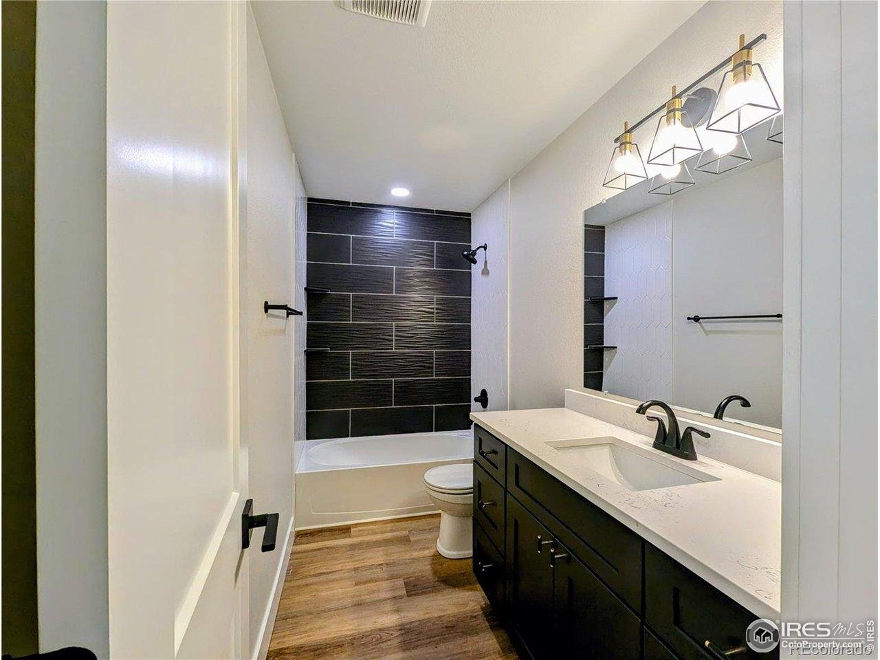 805 Gallup Road Fort Collins, CO 80521 - Photo 11 of 14 a bathroom with a sink a toilet a shower and a mirror
