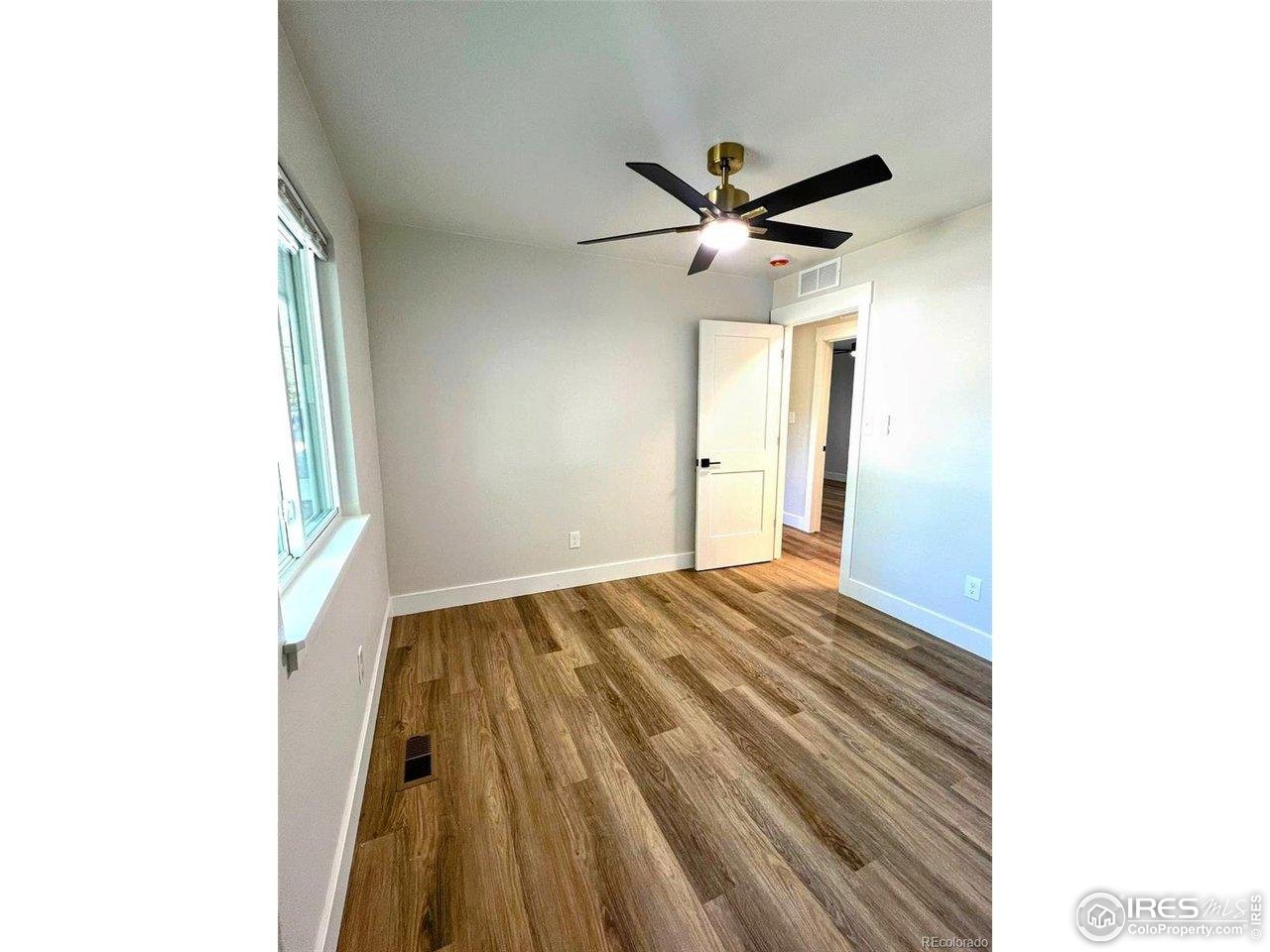 805 Gallup Road Fort Collins, CO 80521 - Photo 9 of 14 a view of empty room with wooden floor