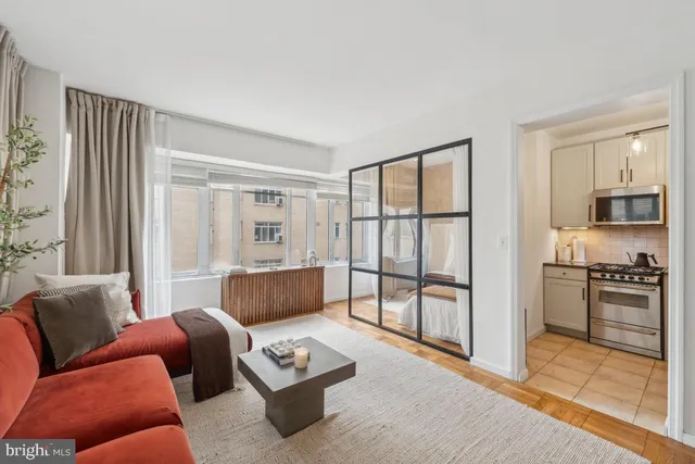 a living room with furniture and a large window