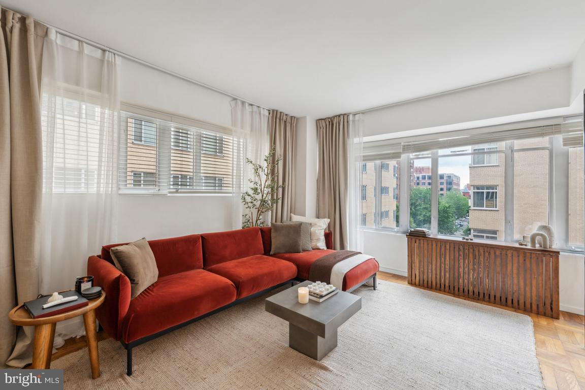 1711 Massachusetts Avenue Northwest, Unit 413 Washington, DC 20036 - Photo 4 of 20 a living room with furniture and a large window