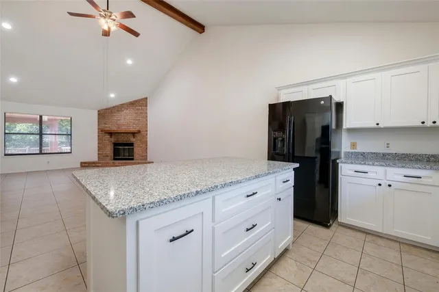 a bedroom with a bed chandelier and a window