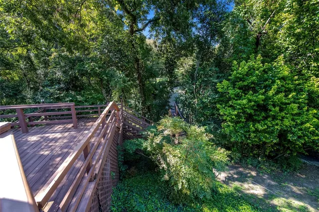 a balcony with wooden floor and trees