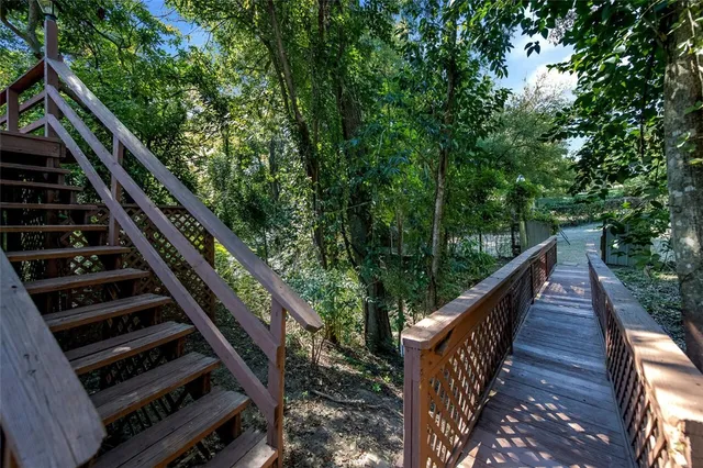 a view of balcony with wooden floor and fence
