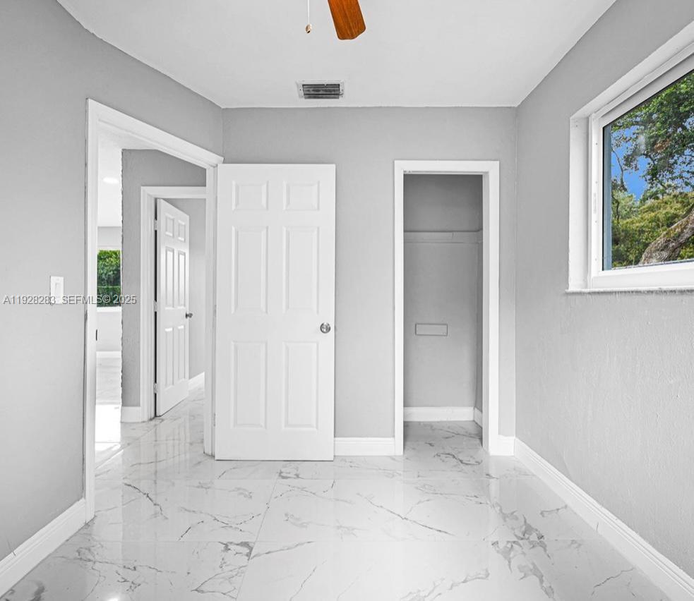 4960 Southwest 28th Terrace Dania Beach, FL 33312 - Photo 6 of 10 an empty room with windows and closet