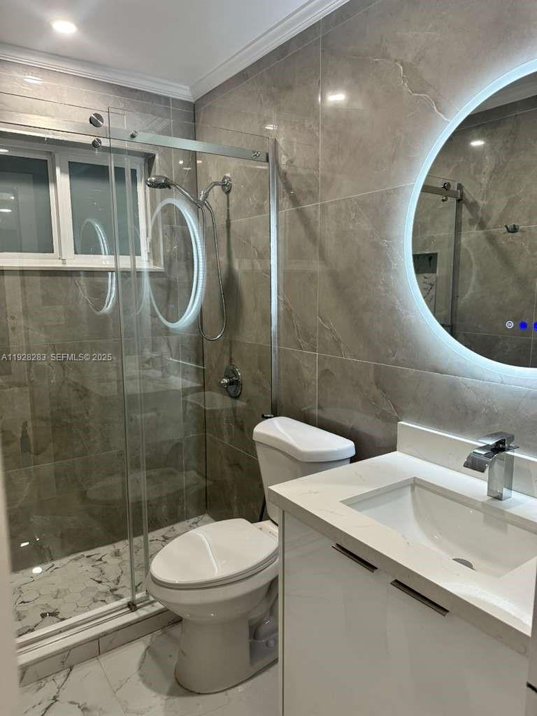 4960 Southwest 28th Terrace Dania Beach, FL 33312 - Photo 9 of 10 a bathroom with a sink a toilet and shower