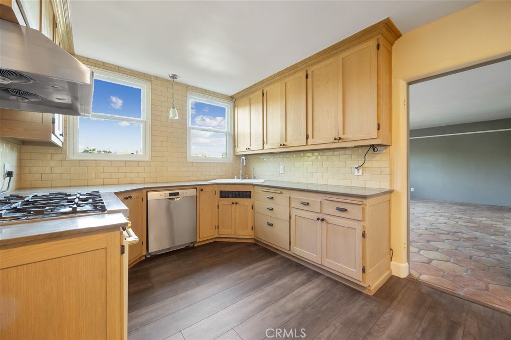 1620 Ina Drive Glendale, CA 91206 - Photo 16 of 31 a kitchen with cabinets appliances a sink and a window