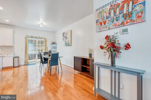 a view of a dining room with furniture a chandelier and wooden floor