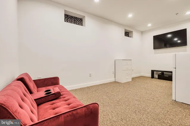 a living room with furniture and stairs