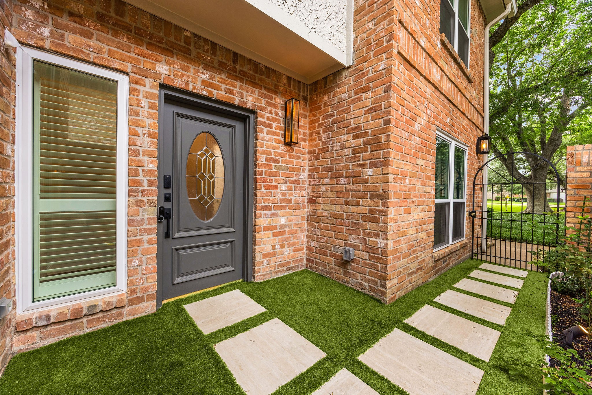 727 Bunker Hill Road, Unit 26 Houston, TX 77024 - Photo 2 of 25 The owner updated the front entry with low-maintenance turf and updated light fixtures.