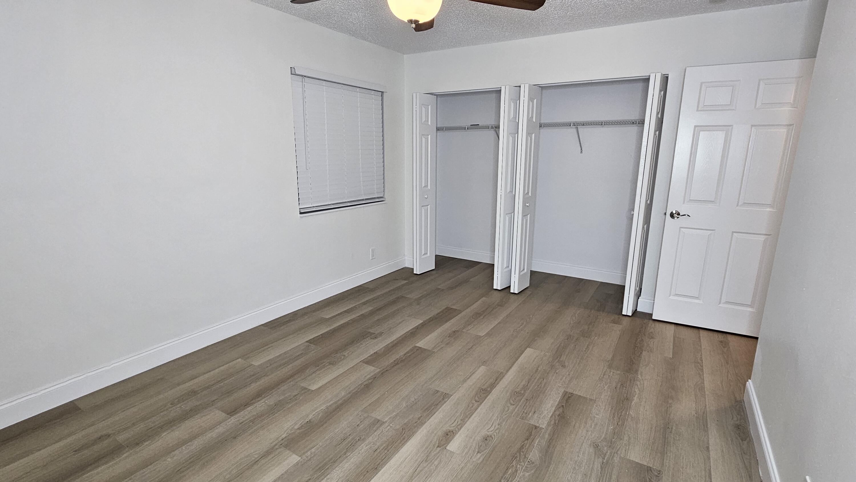 18974 Cloud Lake Circle Boca Raton, FL 33496 - Photo 11 of 29 a view of a room with wooden floor and window