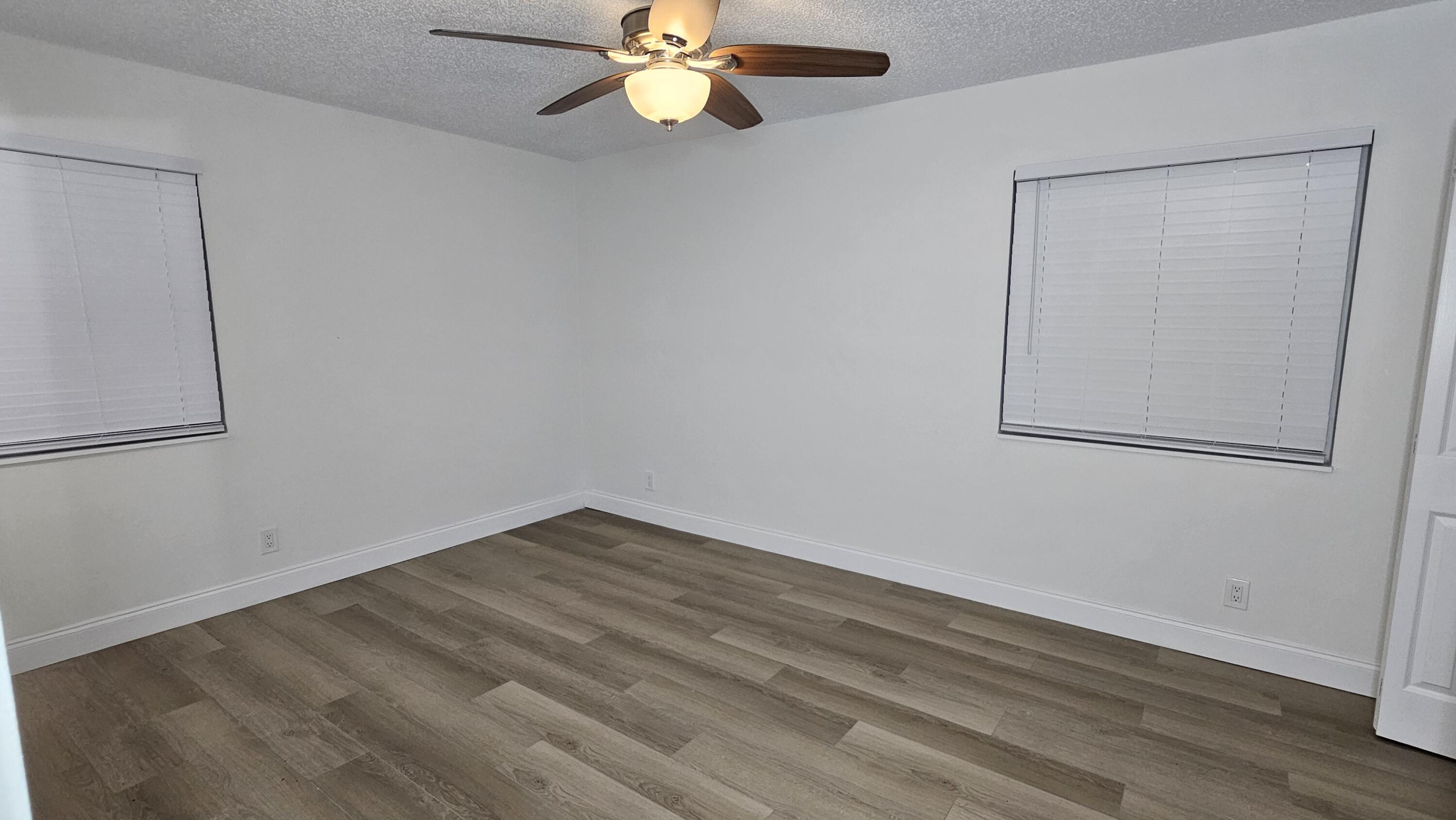 18974 Cloud Lake Circle Boca Raton, FL 33496 - Photo 14 of 29 a view of an empty room with wooden floor and a window