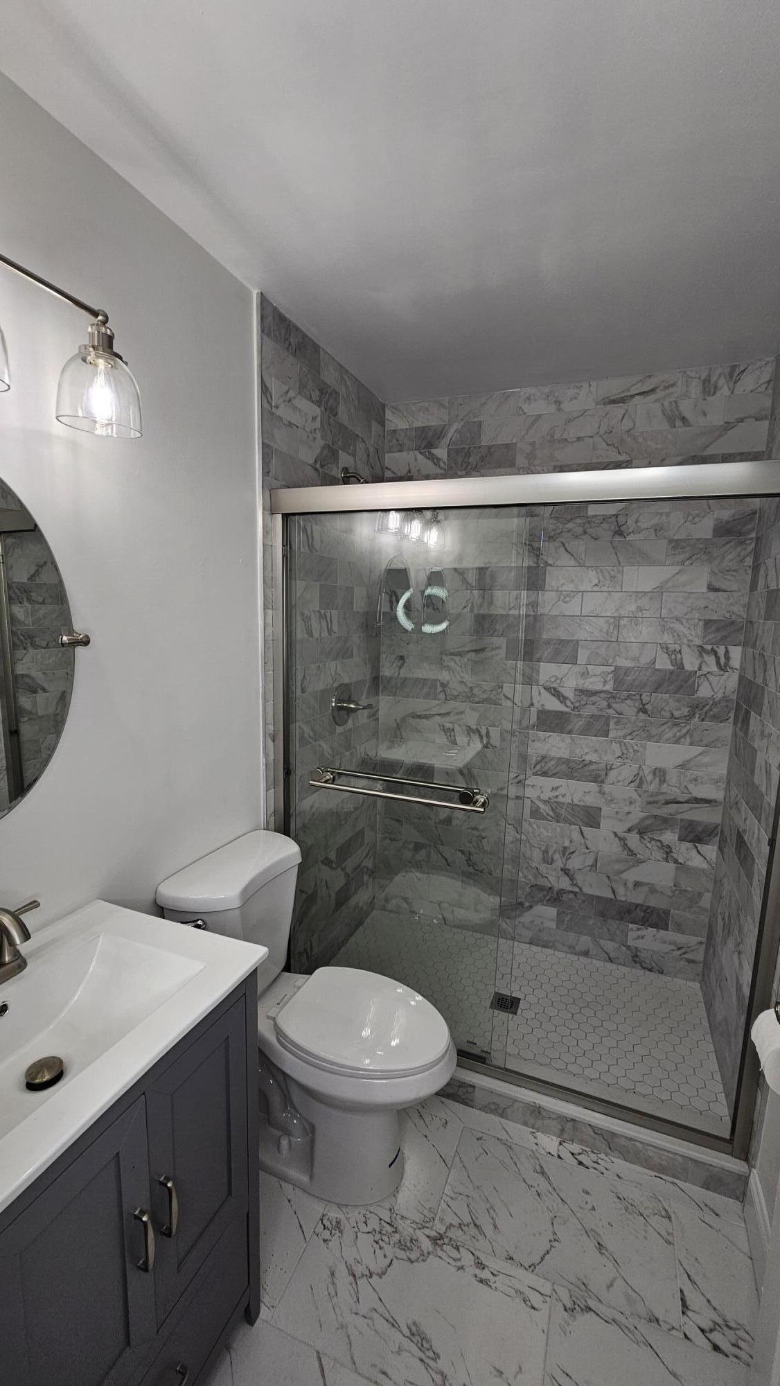 18974 Cloud Lake Circle Boca Raton, FL 33496 - Photo 17 of 29 a bathroom with a toilet sink and shower
